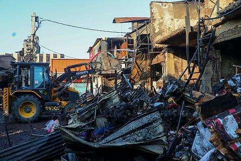 ammu: Damaged structures lie opposite to an earthmover after a fire broke out at Shiv Market opposite the Jammu Railway Station, in Jammu, Monday, Oct. 26, 2026