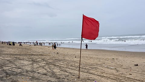 A red warning flag flutters at a deserted beach as tourists and visitors stay away ahead of the expected landfall of severe cyclonic storm 'Arnab', in Puri, Odisha