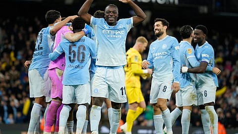 Manchester City players celebrate at the end of the English League Cup soccer match between Manchester City and Brighton and Hove Albion in Manchester, England