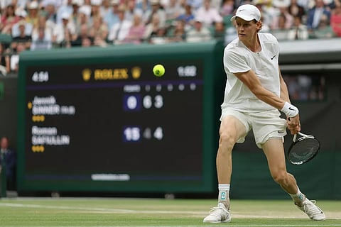 Italy’s Jannik Sinner returns the ball to Russia’s Roman Safiullin