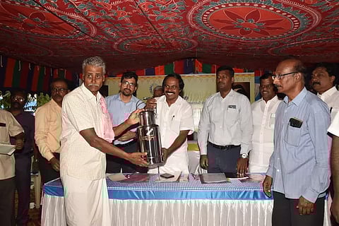 Minister Mano Thangaraj giving away a milk can to a beneficiary in Coimbatore on Thursday