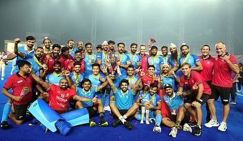 India players and support staff pose with the Asian Champions trophy