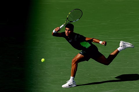 Carlos Alcaraz returns a shot to Max Purcell