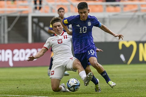 Argentina’s Claudio Echeverri (R) dribbles past Poland’s Kolanko in a group stage clash earlier this month
