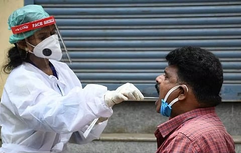 A health worker conducts Covid testing.