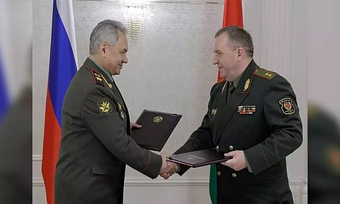 Russian Defence Minister Sergei Shoigu shakes hands with Belarusian Defence Minister Victor Khrenin 