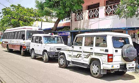 Vehicles of by I-T officials parked near a house at Gandhigram in Karur on Saturday
