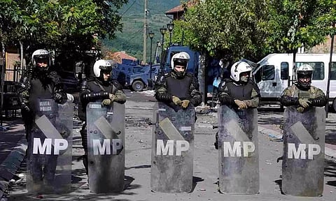 Polish Kosovo Force (KFOR) soldiers stand guard at a municipal office in Zvecan, Kosovo 