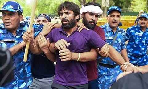 Wrestler Bajrang Punia being stopped during the protest march from Jantar Mantar to new Parliament House.(ANI) 