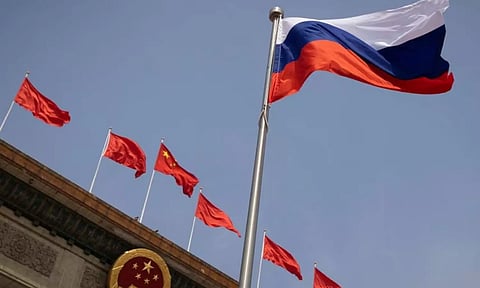 The Russian national flag flies in front of the Great Hall of the People before a welcoming ceremony for Russian Prime Minister Mikhail Mishustin in Beijing, China