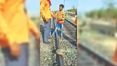 Minor boy being scolded by a few railway trackmen