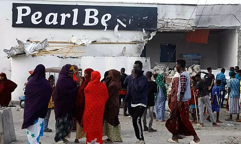  Residents gather outside the Pearl Beach Restaurant following an attack by Al Shabaab militants