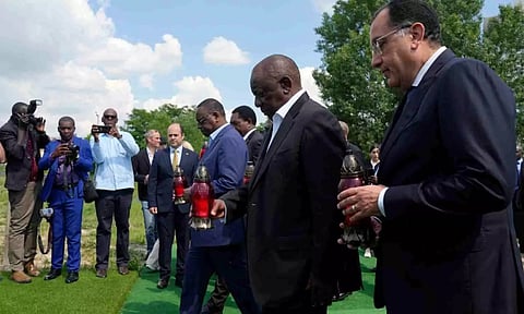 South African President Cyril Ramaphosa, second from right, Senegal’s President Macky Sall, centre, and Egypt’s Prime Minister Mustafa Madbuly, right, attend a commemoration ceremony at a site of a mass grave in Bucha, on the outskirts of Kyiv, Ukraine (AP)