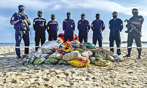 Indian Coast Guard with seized sea cucumbers near Mandapam