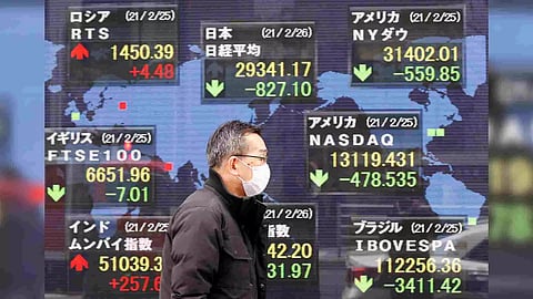 A man walks past a stock quotation board at a brokerage in Tokyo, Japan (Photo: Reuters)