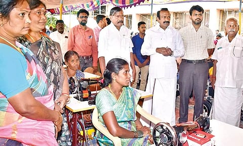 Prohibition and Excise Minister S Muthusamy distributing welfare aid to beneficiaries in Erode on Monday.