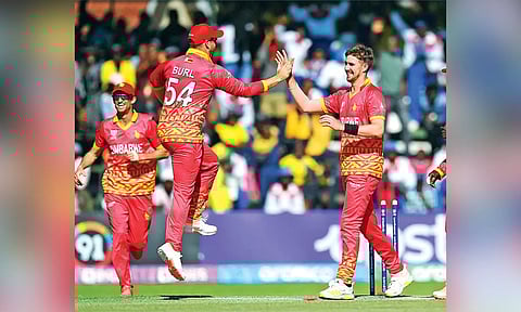 Zimbabwe players celebrate a fall of wicket.