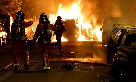Riots after a teenager shot dead by police in Paris suburb (Reuters)