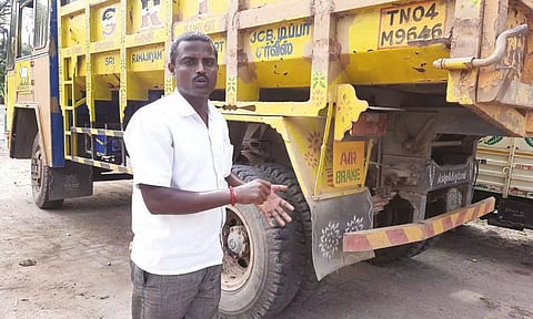 Sand miner Vinayagam and his seized tipper lorry from which parts were allegedly stolen by police