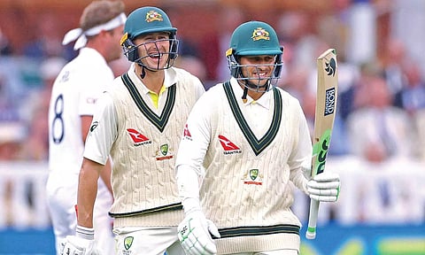 Australia opener Usman Khawaja celebrates reaching his half-century.