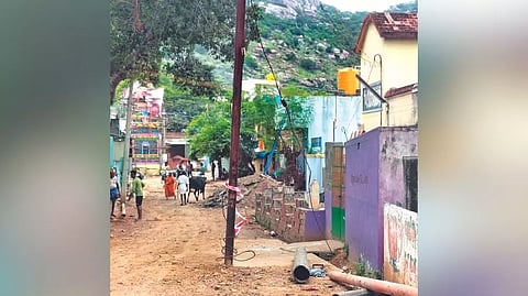 Electricity pole standing in the middle of the road