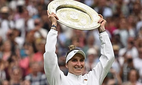 Marketa Vondrousova celebrates with the Wimbledon trophy (Reuters)