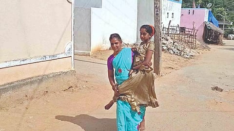 Anitha seen carrying Gowrimani to school (file photo)