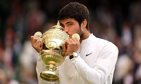 Carlos Alcaraz celebrates with the trophy after beating Novak Djokovic at Wimbledon. (Twitter/@carlosalcaraz)