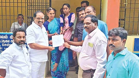 Officials handing over admission papers of Gudiyattam GTM College to Gowrimani (carried by her mother Anitha)