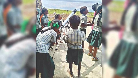 Children watching Chandrayaan launch using a telescope