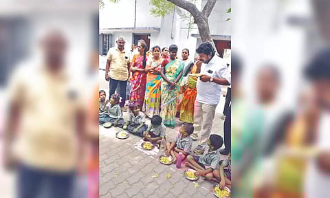 Children eating in the open at Katpadi PU school on Tuesday.