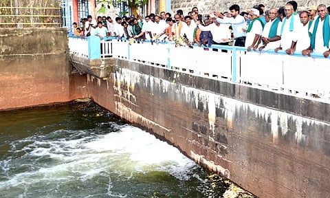 Erode Collector Raja Gopal Sunkara and other officials shower flowers following release of water from Bhavani Sagar dam in Erode, on Tuesday