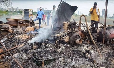 Locals in Gurugram look at burnt items at a shop that was set ablaze by miscreants in a fresh case of communal violence. (PTI)