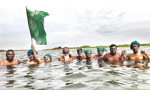 Farmers stage a protest in Kollidam river in Tiruchy on Friday
