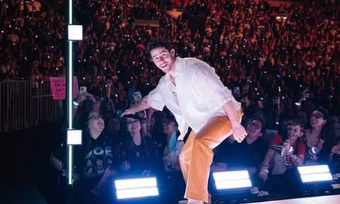 First, it was a bra, now it’s a wristband strike on Nick Jonas