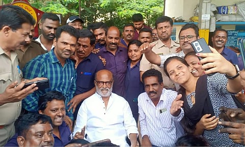 Actor Rajinikanth with his fans clicking a selfie at BMTC in Bengaluru. (ANI)