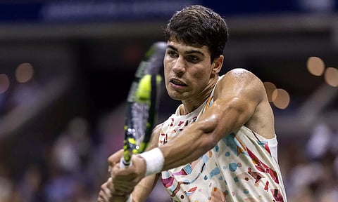 Spain’s Carlos Alcaraz plays a backhand return against Germany’s Dominik Koepfer during the US Open tennis tournament