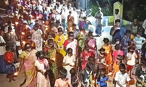Villagers cover their eyes with black cloth during the protest on Wednesday