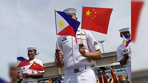 Philippine Navy personnel with national flags of China and the Philippines. (Photo/Reuters)