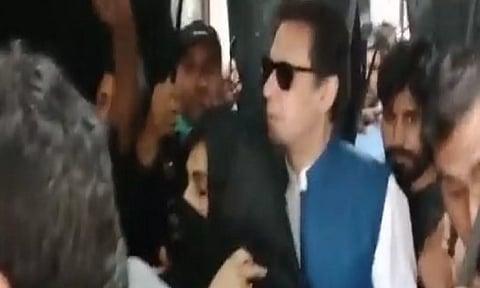 PTI Chief Imran Khan with his wife Bushra Bibi. (Photo Credit - X/The Truth International)