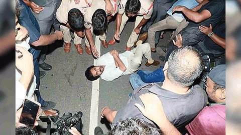 JSP chief Pawan Kalyan lies down on road in protest. (Photo/ANI)