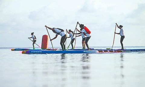 Surfers practicing surfing .