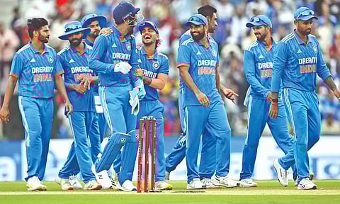 India celebrates the fall of an Australian wicket in the first ODI