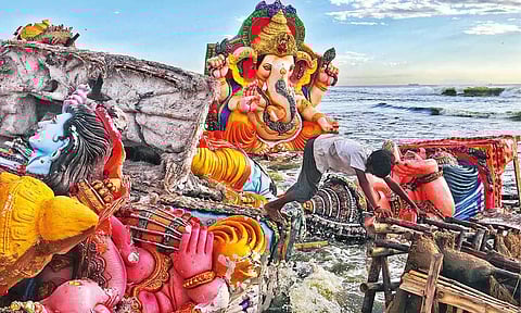 Partially dissolved idols washed up on Pattinambakkam beach