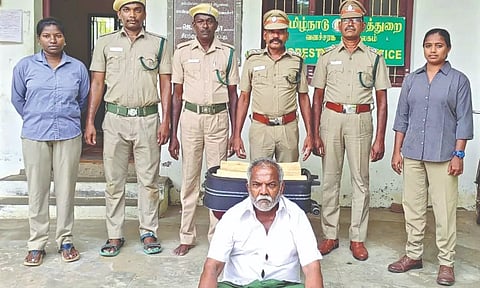 Police with arrested Rajkumar and seized sandalwood