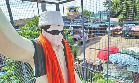 MGR statue with a saffron towel draped over shoulders