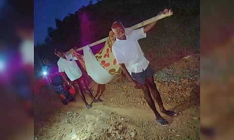 A pregnant woman being taken in a ‘dholi’ to a PHC from Neknamalai area in Tirupattur