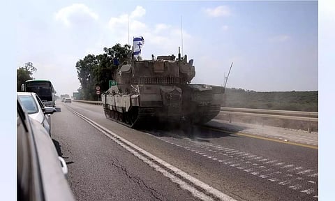 An Israeli tank drives on a road following a mass infiltration by Hamas gunmen from the Gaza Strip, near Sderot in southern Israel (REUTERS)