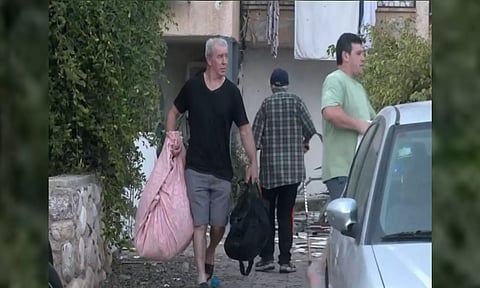 People flee residential buildings after Hamas launches rocket attack in southern Israel (ANI)