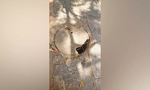 A broken manhole on the pavement near Egmore bus stop